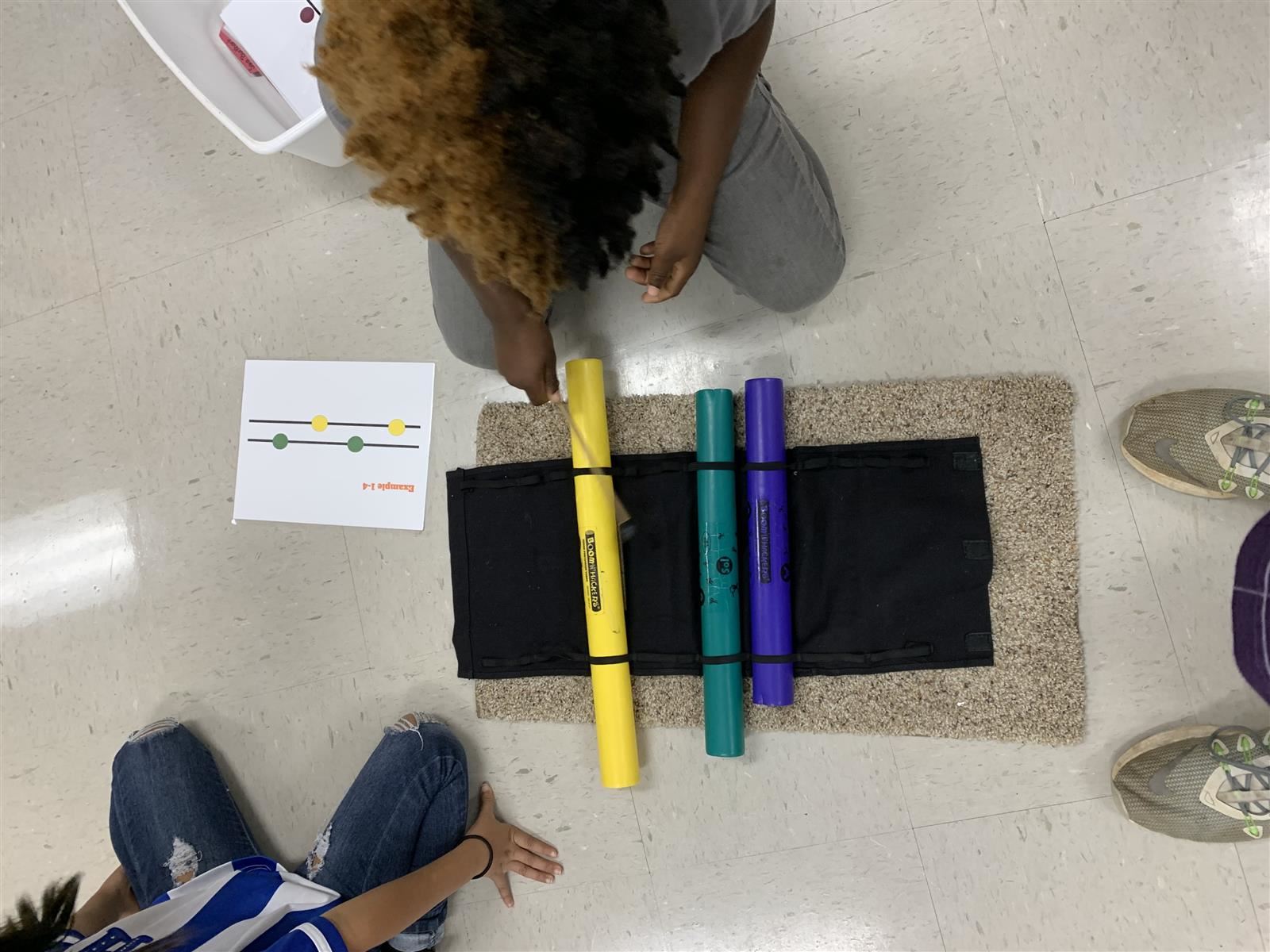 Practicing reading, and playing Mi-Sol-La patterns on a xylophone